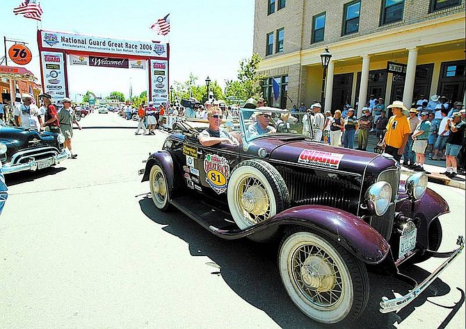 Shannon Litz/Appeal News Service Navigator Franklin Murphy, of Los Angeles, and driver Stan Jones, of Woodland Hills, Calif., drive down Esmeralda Avenue in a 1932 Ford Roadster during the National Guard Great Race lunch stop Thursday in Minden.