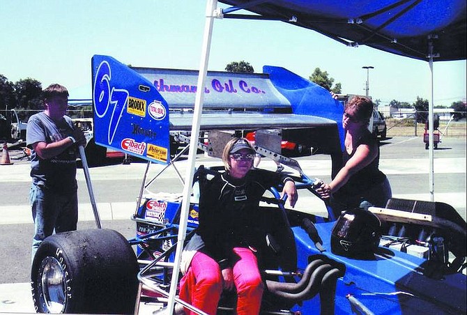 Supermodified driver Amy Barnes, center, takes a break from testing Saturday while at Shasta Raceway Park in Anderson, Calif. Her dad, Dan, and mom, Kathy, are owners of the racecar. All are residents of Minden.