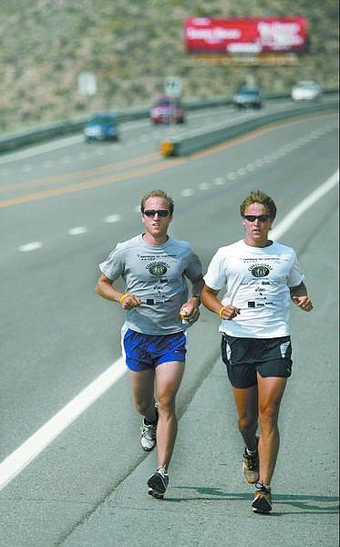 Cathleen Allison/Nevada Appeal Matthew Pierson, left, and Christian McEvoy run down Spooner Summit on Tuesday morning as part of a 3,500-mile run to raise money for cancer survivors. The Coast to Coast: A Run for Survivorship is a six-month, cross-country journey.