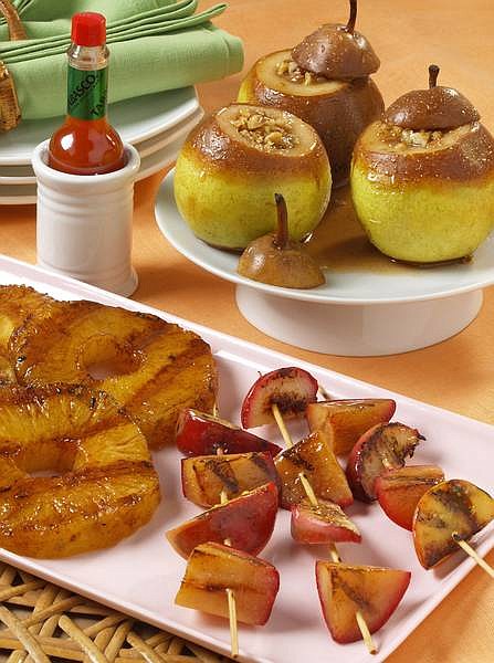 A trio of grilled-fruit dishes: front left, Spicy Island Grilled Pineapple; front right, Sweet and Spicy Fruit Skewers; rear, Fire-Roasted Stuffed Pears.   McIlhenny/Tabasco photo