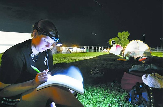 Chad Lundquist/Nevada Appeal Cynthia Breene, 24, of Truckee, works on project notes in her down time at the Dayton Valley High School command staging center. Breene is a member of the Tahoe National Forest Engine 61, which spent the last two days subduing the Six Mile 2 fire.