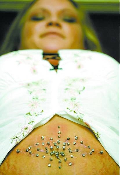 BRAD HORN/Nevada Appeal Tamara Pachak, 23, of Carson City, now has 25 navel piercings after a session at Spear Me on Friday. Pachak was attempting to set a record for the Guinness Book of World Records.