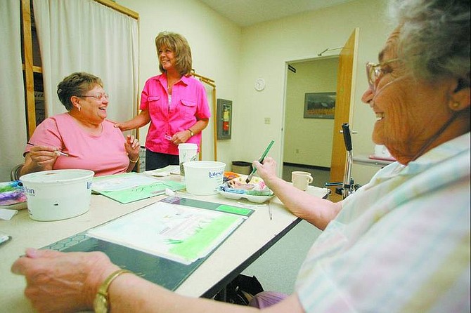 BRAD HORN/Nevada Appeal Judy Kassemos, center, the new volunteer coordinator at the Carson City Senior Citizen&#039;s Center, talks with students studying watercolor painting at the center on Wednesday.