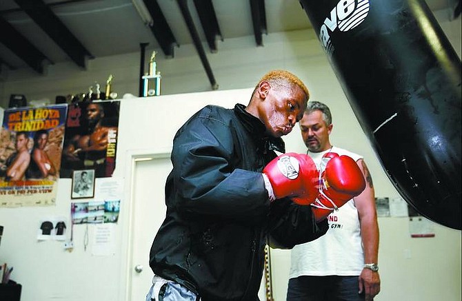 Chad Lundquist/Nevada Appeal South Africa&#039;s Silence Mabuza hits the heavy bag while assistant trainer Dawie Lotter times him at the Carson City Boxing Club on Tuesday. The 28-year-old Mabuza will challenge IBF bantamweight champion Rafael Marquez Saturday at MontBleu Resort Casino and Spa.