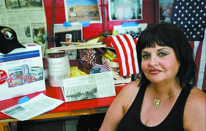 Chad Lundquist/Nevada Appeal  P.J. Degross sits in a work area where she organizes efforts to support men and women in the military who are deployed abroad. The Carson City Board of Supervisors will issue a proclamation today honoring her for her work.