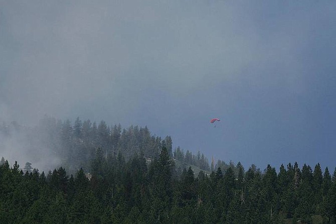 Brad Horn/Nevada Appeal A smokejumper parachutes onto a hill near the Genoa Peak fire above Genoa on Saturday. Ground attack on the fire was hampered by steep terrain and limited access.