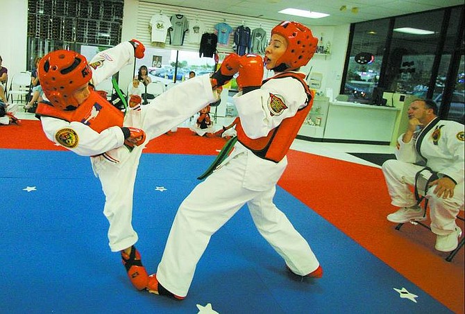 BRAD HORN/Nevada Appeal Jacob Bertocchi spars with his mother, Michelle, during class at ATA Black Belt Academy.