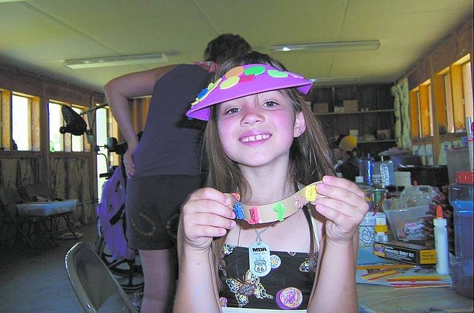 Leah Seal participates in a craft project at the Muscular Dystrophy camp.   Submitted Photo