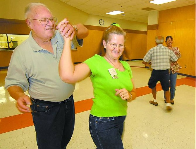 photos by Kevin Clifford/Nevada Appeal Howard English, left, and Flora Berry, right, members of the Dayton Silver Squares square dance Thursday night at Dayton High School.