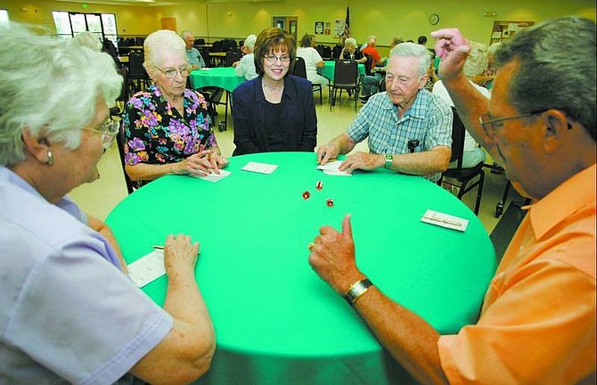BRAD HORN/Nevada Appeal Janice McIntosh, director at the Carson City Senior Citizens Center, center, watches a game in the dining room area with Mary Edwards, from left, Lavonne Cawley, Chet Guier and John Brownell on Friday afternoon.