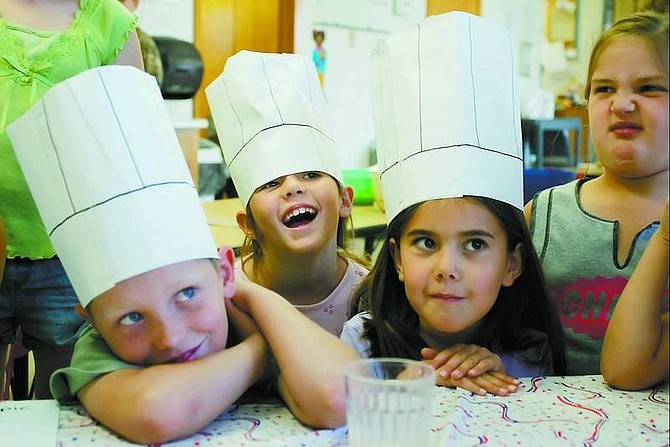 Reese Michael, 7, from left, Kaitlin Duarte, 6; Hannah Harris, 7; and Taylor Furr, 6, all of Dayton, listen to results in the Kids Iron Chef contest.