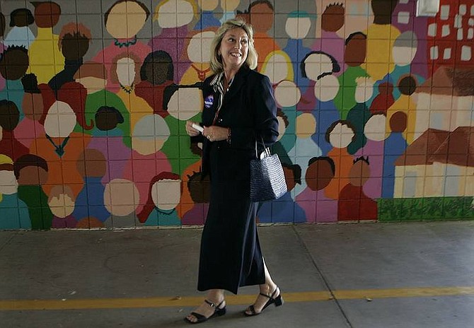 Laura Rauch/Nevada Press Democratic candidate for governor Dina Titus leaves Lewis E. Rowe Elementary School in Las Vegas after voting in the primary on Tuesday. Titus will face Republican Jim Gibbons, above right, in the general election.