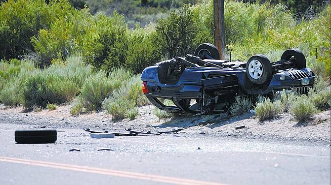 Chad Lundquist/Nevada Appeal A Washoe Valley woman and a boy were injured after, for unknown reasons, she swerved, overcorrected, and rolled her Jeep Cherokee on Old Highway 395 Tuesday.