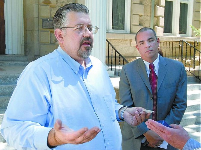 Kevin Clifford/Nevada Appeal Phil Alfano, left, brother of deceased state controller Kathy Augustine, answers questions during a family press conference to thank Augustine&#039;s supporters Wednesday at the Capitol. Dion Gazzaruso, right, Augustine&#039;s cousin, listens.