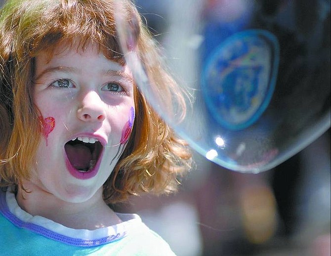 Kevin Clifford/Nevada Appeal Maggie Panelli, 4, of Sparks, reacts after blowing a bubble at the bubble mania station during the Kids Karnival at the Children&#039;s Museum of Northern Nevada in Carson City on Saturday. The fifth annual fundraiser for the Children&#039;s Museum featured many activities including a dinosaur dig, a cake walk and miniature golf.