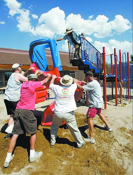 Chad Lundquist/Nevada Appeal Parents, teachers and administrators volunteered Sunday afternoon at Seeliger Elementary School to put in playground equipment that was purchased through donations and funding from the school district and Parent/Teacher Organization.