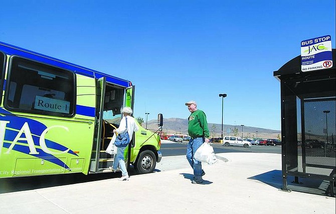 Kevin Clifford/Nevada Appeal Herb and Millie Karsky, of Carson City, board a Jump Around Carson bus near Wal-Mart on Tuesday. The JAC system is a fixed-route service that has been online since October.