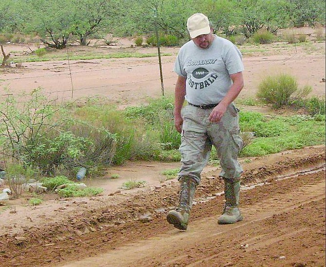 STEVE RANSON/Nevada Appeal News Service John Lindemuth, an archeologist with the Gulf South Research Corp., of Baton Rouge, La., surveys a recently graded road on the Tohono O&#039;Odham Indian Reservation. He help ensure the Nevada Air National Guard did not disturb ancient artifacts or ruin ancestral sites on the reservation, the second largest in the United States.