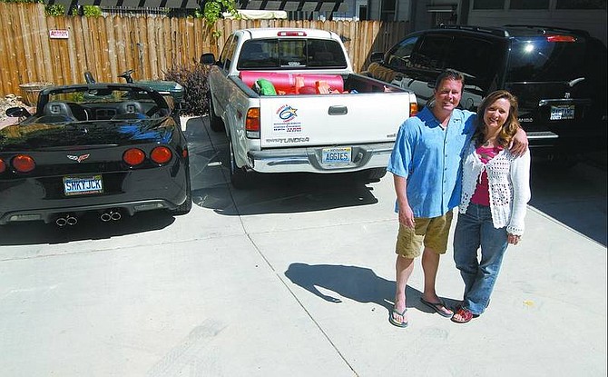Kevin Clifford/Nevada Appeal Allison and Jack McLaughlin stand next to their cars, which have vanity plates, at their home Friday. The cost for personalized plates is $36, in addition to the normal registration and fees. Many Nevada drivers use vanity plates as yet another expression of individuality.