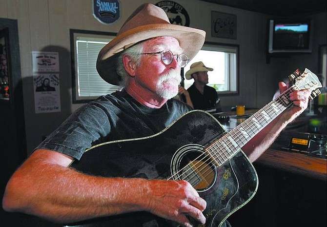 Chad Lundquist/Nevada Appeal Tom Zachry of Dayton plays his guitar at The East 50 bar in Dayton. Zachry plays old-time cowboy and folk songs on the first Monday of every month at the bar.