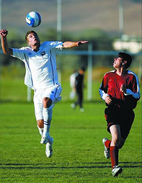 Chad Lundquist/Nevada Appeal Carson High&#039;s #16 Christian Volker heads the ball while Elko&#039;s #11 Zachary Penrod watches during Tuesday&#039;s game.