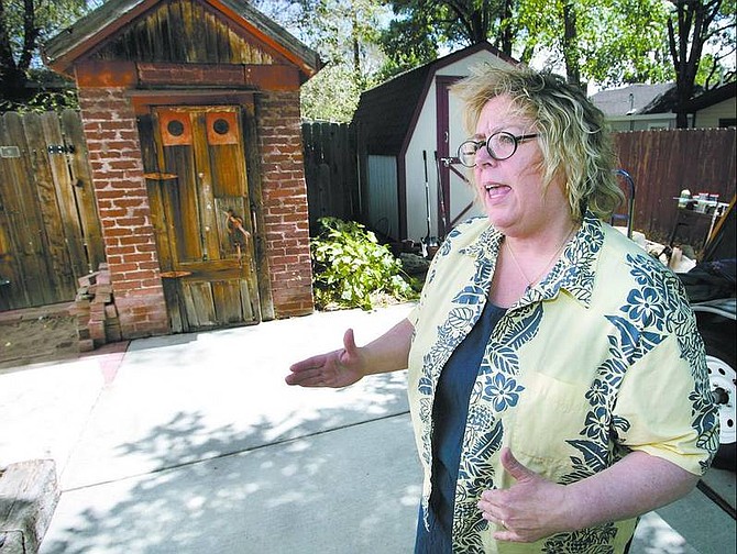 Cathleen Allison/Nevada Appeal Denis Budge talks about the 19th century ice house in the back yard of her Carson City home on Tuesday. She and her husband, Mike, believe it was used by the Pony Express in Carson City, which dates it to 1860.