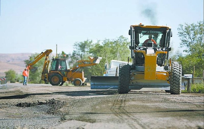 Cathleen Allison/Nevada Appeal Lyon County road crews grade Winnemucca Street in Silver Springs on Wednesday. The road department will be chip sealing nearly four miles of residential roads beginning next week.