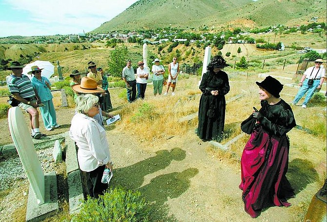BRAD HORN/Nevada Appeal Diane Peters, of Fallon, plays the part of the deceased Hannah Sanders during the &quot;Voices From The Past&quot; cemetery tour at the Silver Terrace Cemetery in Virginia City on Saturday morning. Pictured left of Peters is Kathy Easly, the Widow and show director.