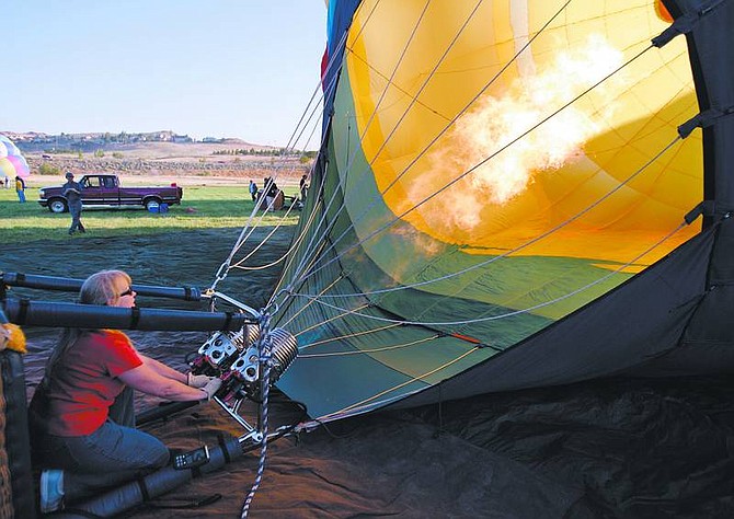 Chad Lundquist/Nevada AppealBalloon pilot Katie Griggs fills Sushi, her giant fish balloon, with hot air Thursday morning at Rancho San Rafael Park for its first flight of the 25th annual Great Reno Balloon Race. Griggs, an Incline Village resident, has been flying balloons for 20 years.