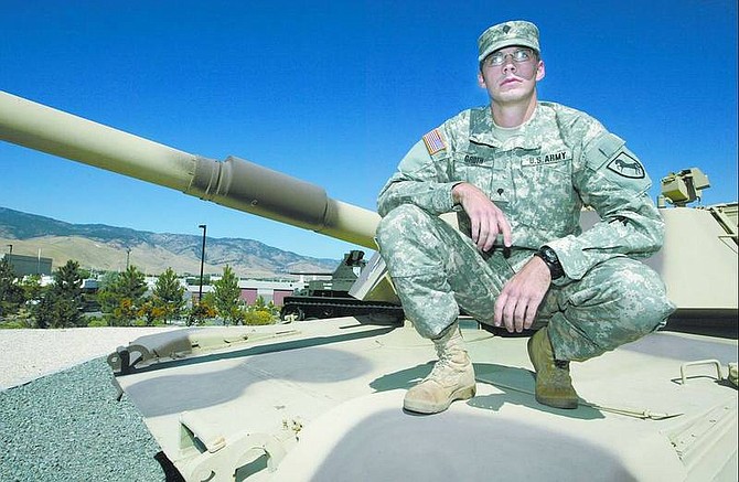 Cathleen Allison/Nevada Appeal Nevada National Guard Spc. Josh Groth, 22, poses with an M1-A1 Abrams tank at the Nevada National Guard facility in Carson City. Groth, with the 1/221 Cavalry Regiment, says he remembers Sept. 11, 2001 &#039;like it was yesterday.&#039; Below, as a senior in high school in this photo soon after the terrorist attacks, Groth, then 17, organized an impromptu patriotic assembly at Carson High School. He says the attacks inspired him to join the military.