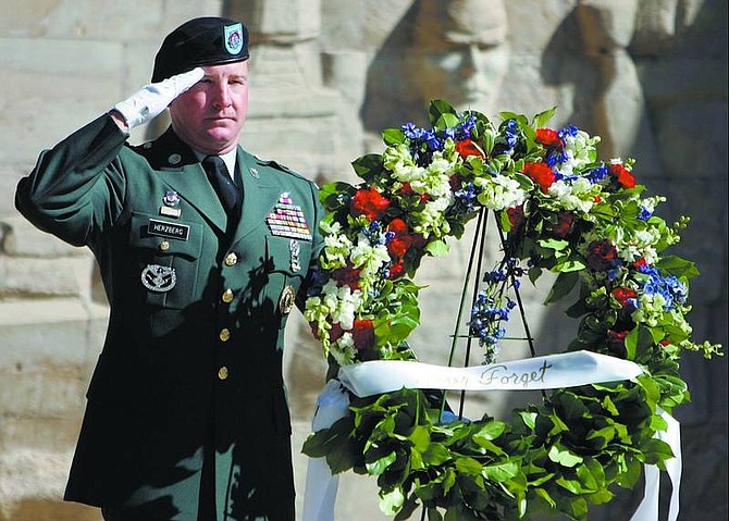 Chad Lundquist/Nevada Appeal Sgt. Maj. Johnny Herzburg of the Nevada Army National Guard salutes during &#039;Taps&#039; at a commemorative ceremony marking the fifth anniversary of September 11, 2001, at the Nevada State Veterans memorial at the Capitol on Monday.