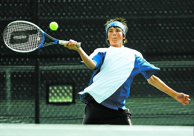 BRAD HORN/Nevada Appeal Carson junior Spencer Trapp, 16, returns a ball during his doubles match with partner James Pelez, 16, at Carson High School on Thursday. The Carson High School mens and womens teams faces Sparks High School on Thursday in Carson CIty.