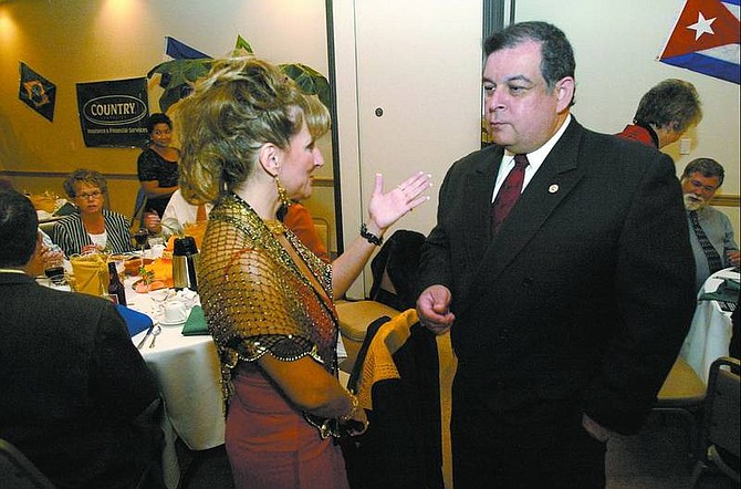 Cathleen Allison/Nevada Appeal Yaraseth Lugo, left, Nevada Hispanic Services employee of the year, talks with J.R. Gonzales, former president of the U.S. Hispanic Chamber of Commerce, during the Salsas Dinner Gala on Friday night at the Plaza Hotel Conference Center.