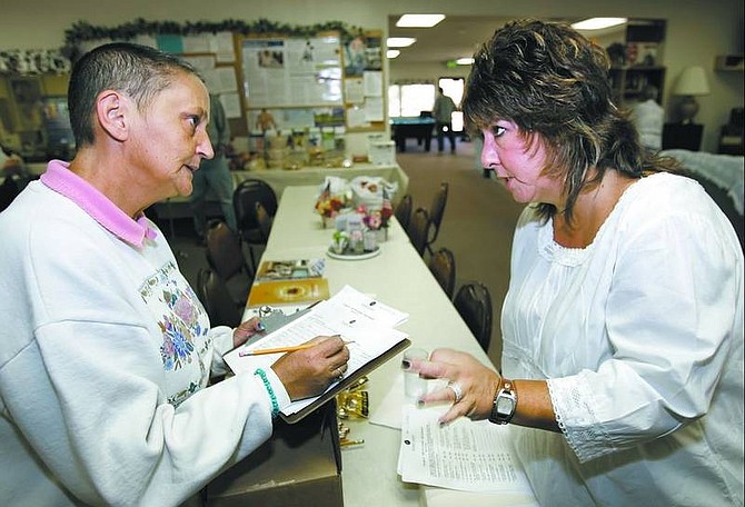 Chad Lundquist/Nevada Appeal Four-time cancer survivor Linda Gorden, left, talks with Tina Kroepel, patient navigator for the Nevada Cancer Institute&#039;s Fallon office. Gorden attended Monday&#039;s discussion at the Dayton Senior Center to obtain more information about options offered by NVCI.