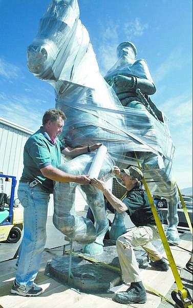 Cathleen Allison/Nevada Appeal Sculptor Thomas Pottage, right, works with Jeff Pate, of Navis, to prepare Pottage&#039;s statue for shipping Tuesday in Mound House. The 13-foot-tall Italian Renaissance horseman statue will be installed in the Granduca Luxury Residential Hotel in Houston on Monday.