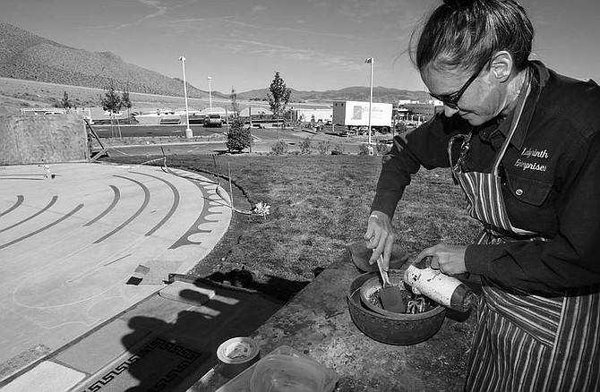 Cathleen Allison/Nevada Appeal Judy Hopen, with Labyrinth Enterprises, mixes colored concrete Friday afternoon outside the Carson Tahoe Cancer Center. Hopen is creating a labyrinth at the entrance to the facility which is expected to open Nov. 6.