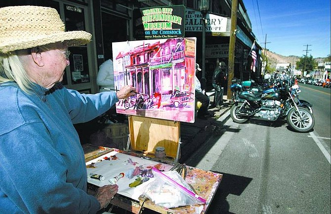 Cathleen Allison/Nevada Appeal Artist Louise Kerr, 81, paints along C Street in Virginia City on Friday afternoon. Kerr is selling tickets to raffle off one of her original pieces as a fundraiser for the VIrginia City Volunteer Fire Department.
