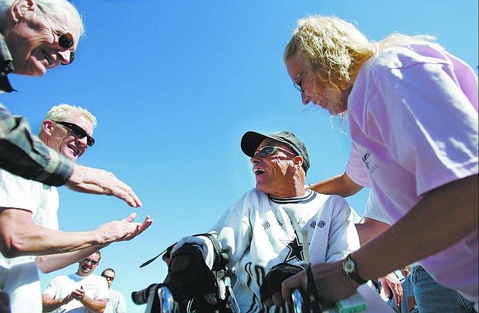 Chad Lundquist/Nevada Appeal Janet Stephens, right, and well wishers waiting at the finish of Glenn Lucky&#039;s successful attempt to pull a 30,000-pound semi-truck and trailer 100 feet. Lucky made his goal of 100 feet in a little under four minutes in the parking lot of Bully&#039;s Sports Bar and Grill on North Carson Street on Sunday.