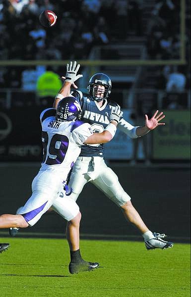 Nevada quarterback Jeff Rowe passes over Northwestern&#039;s  Brendan Smith for a 25-yard touchdown to Robert Hubbard in the first quarter of Friday&#039;s game, Sept. 22, 2006 in Reno, Nev. Nevada won 31-21.(AP Photo/Cathleen Allison)