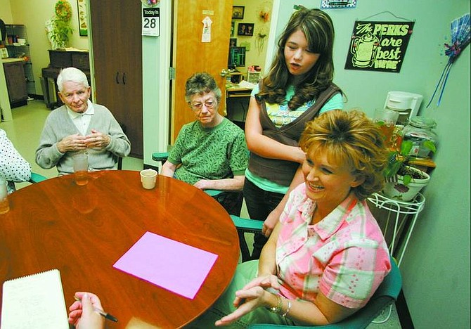 BRAD HORN/Nevada Appeal Louis Murphy, from left, Kay Ferreira, Olivia Stella, 12, and Jody Stella discuss the Alzheimer&#039;s Memory Walk while at the Share the Day center at the Carson City Senior Center on Thursday.