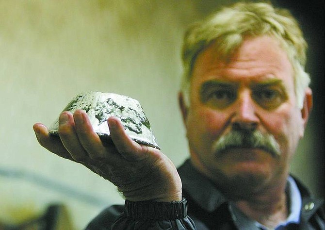 Scott Jolcover, Plum Mining general manager, displays a bell filled with about 15 to 20 ounces of gold in the processing plant at the Plum Mine in Virginia City.