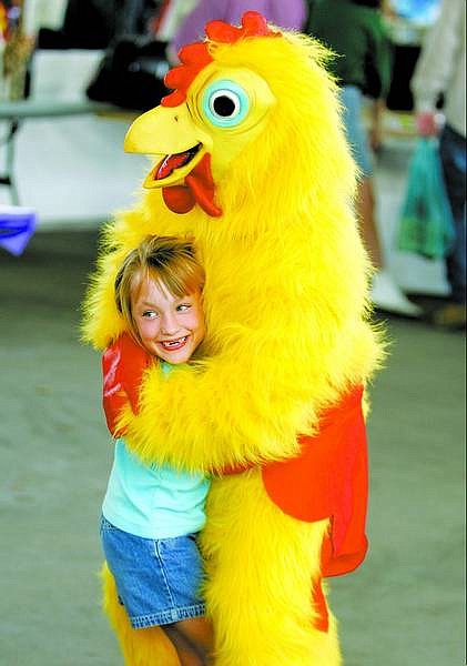 Ciarra Begovich, 7, of Gardnerville, hugs the chicken at the 2005 Oktoberfest celebration at the Pony Express Pavilion at Mills Park. In the chicken suit is Linda King of Carson City.    BRAD HORN/ Nevada Appeal  File Photo