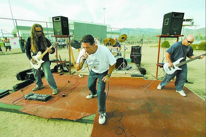 BRAD HORN/Nevada Appeal Hellcraft performs before the beginning of the seventh annual Nevada Department of Corrections Walkathon for cancer care at the Northern Nevada Correctional center on Sunday. The band, from left, is John Davies, guitar; Russell Letsinger, vocals; Michael McInerney, drums; and William Manciano, bass.