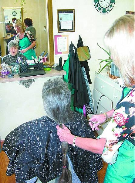 Jarid Shipley/Nevada Appeal Hairstylist Linda Rich chops off the ponytail of Laura Haggart on Friday morning at Shear Designs. Haggart donated her hair to Locks of Love just days before she was set to begin chemotherapy for breast cancer.