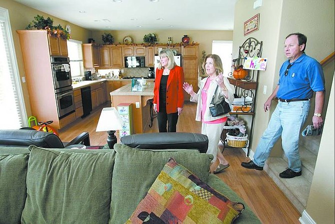 Kathy Tatro, with Coldwell Banker, shows a Silver Oak home to Patti and Doug Eisner on Monday afternoon. The Eisners, of Walnut Creek, Calif., are looking to retire in the Carson City area.   Cathleen Allison/ Nevada Appeal