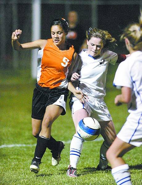 Cathleen Allison/Nevada Appeal Carson&#039;s Ann Sinnott fights for the ball with Kristina Dantin, of Douglas, during Tuesday night&#039;s game at CHS.