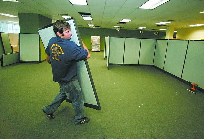 BRAD HORN/Nevada Appeal Zach Downie puts cubicles together at 4126 Technology Way on Wednesday. Downie is a lead installer for Golden Express Office Installation Specialists.
