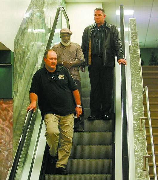 BRAD HORN/Nevada Appeal David Winfield Mitchell, 61, is escorted by Lt. Bob White, left, and Detective Dave Legros of the Carson City Sheriffs Department after arriving in Reno from Las Vegas on Thursday evening.