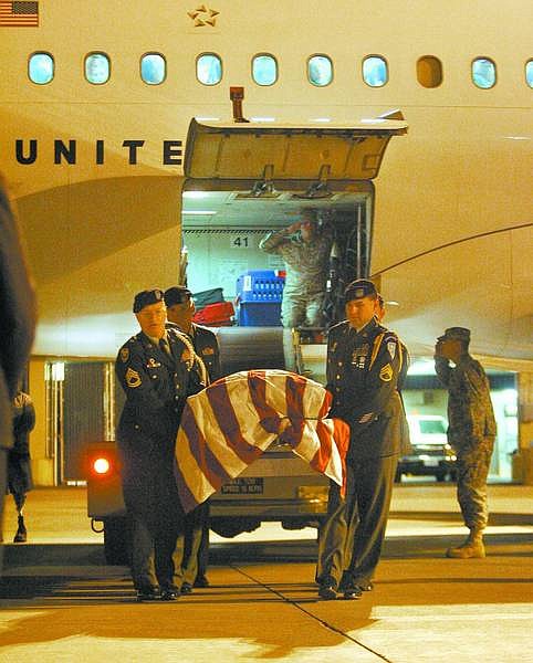 BRAD HORN/Nevada Appeal Army Honor Guardsmen carry the casket of Army Pfc. Brandon Williams off the plane at Reno-Tahoe International Airport on Monday evening. Williams was killed by sniper fire Oct. 9 while serving a mission with the 101st Airborne Division in Baghdad, Iraq.