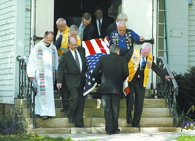 Pall bearers bring the  casket of Bill Dolan out of the St. Peters Episcopal Church on Tuesday morning. Dolan, 83, was a lifelong Nevadan and a Nevada Appeal columnist for 59 years.              Cathleen Allison/ Nevada Appeal